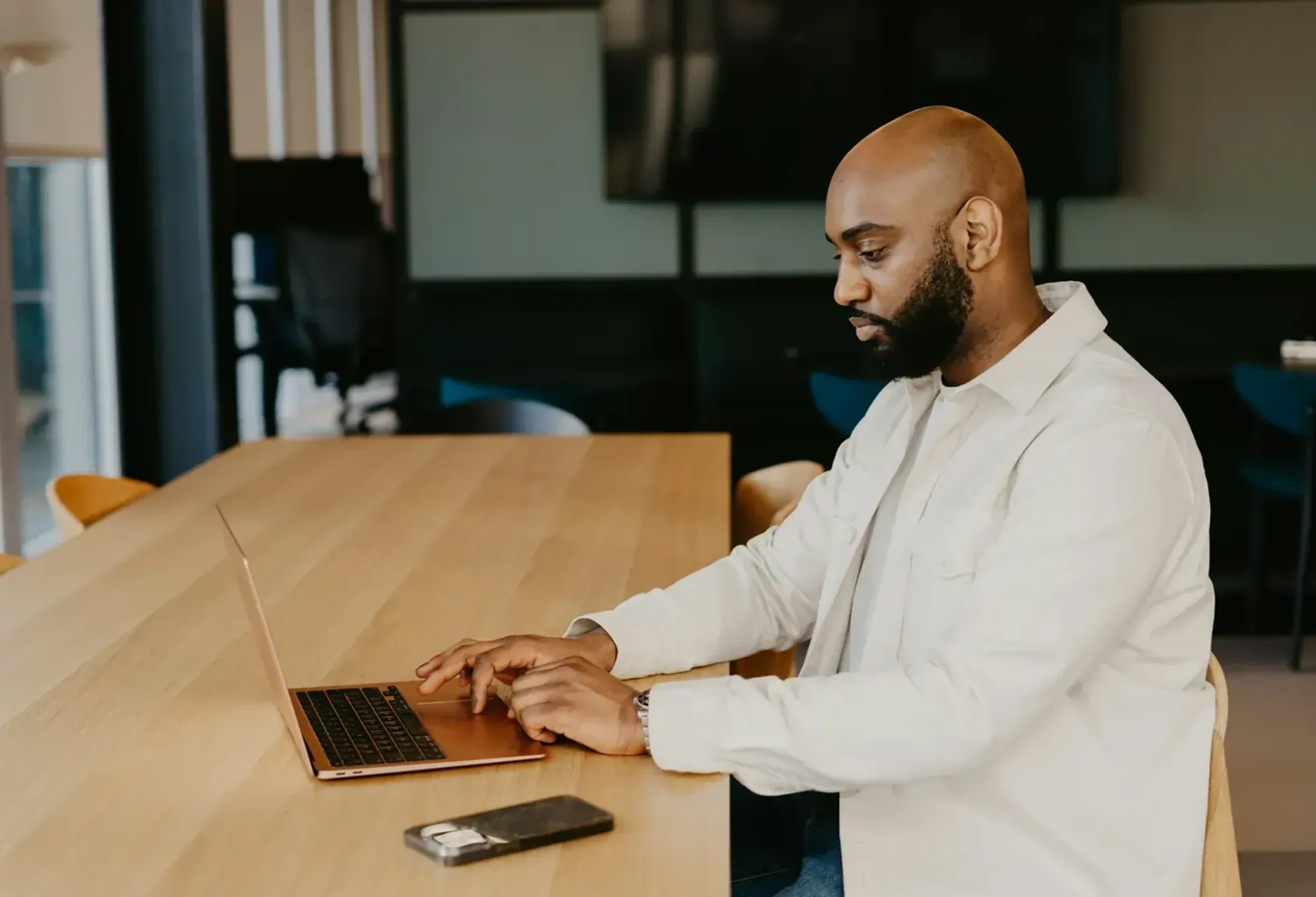 Man on laptop using WriteHuman to convert AI to human text.