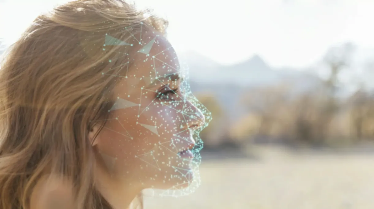 Woman&rsquo;s profile with digital facial recognition network overlay.